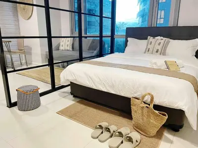 a bedroom with a bed with shoes on the floor at Gora studio in Avant BGC parking with fee in Manila