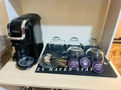 a coffee maker sitting on top of a table at #46 Urban Deca Homes Ortigas in Manila