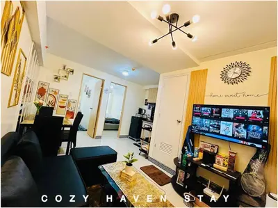 a living room with a couch and a table at #46 Urban Deca Homes Ortigas in Manila
