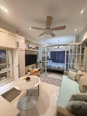 a living room with a couch and a table at Luxury Condo with a view of Manila Bay in Manila