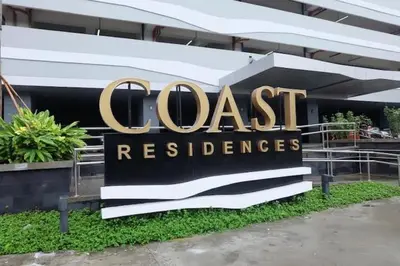 a sign in front of a building that reads coast residence at Luxury Condo with a view of Manila Bay in Manila