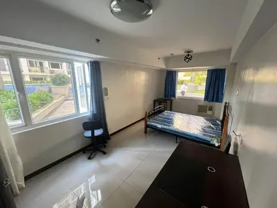 an empty room with a bed and a window at Solemare Parksuites Condominium in Manila