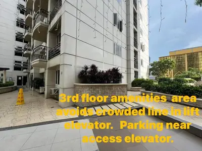 a building with a sign that reads bird floor amenities are a walkowedmean elevator at Solemare Parksuites Condominium in Manila