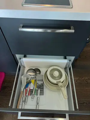 a drawer with some utensils in a cabinet at Acqua Private Residences - Livingstone Tower (Makati - Mandaluyong) in Manila