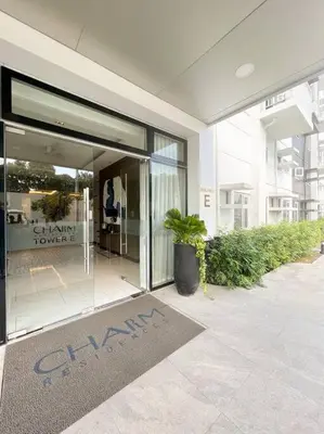 a building with a sign in front of a glass door at Casa Dona Suites at SMDC Charm Residences in Manila