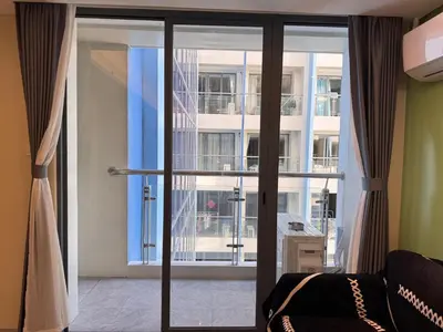 a room with a sliding glass door with a balcony at Studio with Balcony Near Okada Manila and MOA LCONDOTEL in Manila