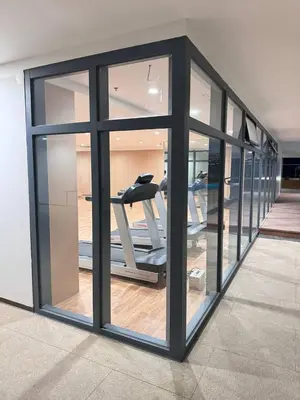 a gym with glass windows and a treadmill at Studio with Balcony Near Okada Manila and MOA LCONDOTEL in Manila