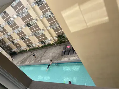 an overhead view of a swimming pool in front of a building at Stanford Suites 3, staycation near Nuvali, located in Silang in Bayabasan