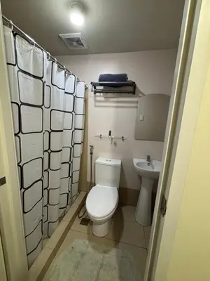 a small bathroom with a toilet and a sink at Stanford Suites 3, staycation near Nuvali, located in Silang in Bayabasan