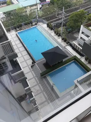 an overhead view of a large swimming pool on a building at Mezza II Residences Condotel by Czarynah's Crib in Manila