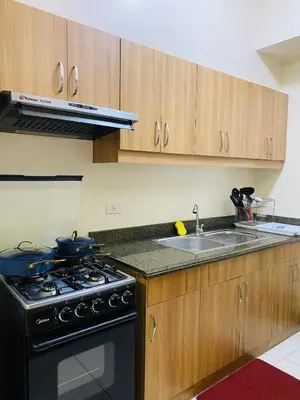 a kitchen with a stove and a sink at Hello condo in Manila
