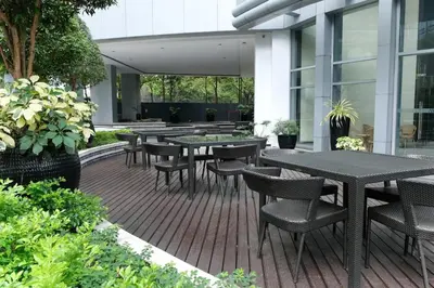 a patio with tables and chairs in a building at Solana in Avant BGC parking with fee in Manila