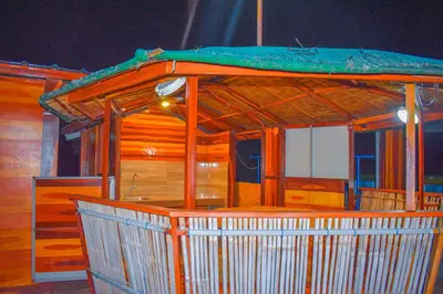 a small building with a green roof on top of it at Casa de Madera The Wooden House Staycation Transient and Private Resort in Cabuyao