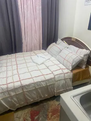 a bed sitting in a room next to a sink at Pierrecondotel in Manila