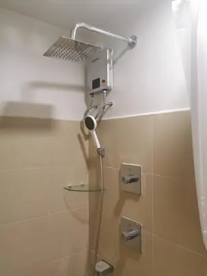a shower with a shower head in a bathroom at Mall of Asia shore 3 residence in Manila