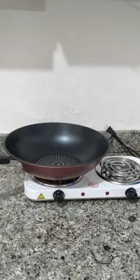 a pan on top of a burner on a stove at Sorrel Residences- 2 Bedroom Apartment in Manila