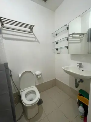 a bathroom with a toilet and a sink at Grace Residences Condo 1 BR Poolview near McKinley BGC in Manila