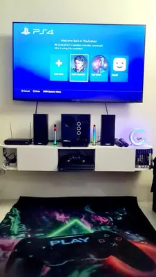 a flat screen tv sitting on top of a table at HeRo's Lair - Staycation near EK with Ps4 & more! in Santa Rosa