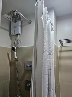 a shower with a shower curtain in a bathroom at Haven of Tranquility Suite - SMDC Shore 3 (MOA) in Manila