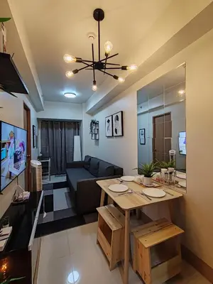 a living room with a table and a couch at Haven of Tranquility Suite - SMDC Shore 3 (MOA) in Manila