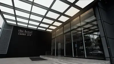 a building with a sign on the side of it at Green Sun Hotel in Manila
