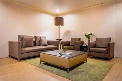 a living room with two couches and a coffee table at Green Sun Hotel in Manila