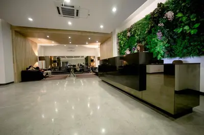 a lobby with a large wall of plants at Green Sun Hotel in Manila