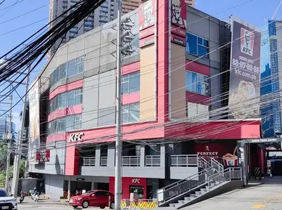 a building with a red car parked in front of it at 1BR Condotel Suite at Sunshine100 City Plaza #SS06 in Manila
