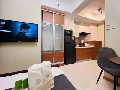 a kitchen with a television on the wall of a room at 1BR Condotel Suite at Sunshine100 City Plaza #SS06 in Manila
