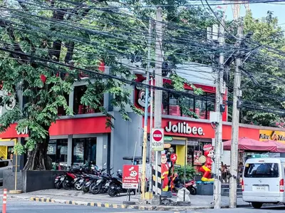 a street with motorcycles parked in front of a building at 1BR Condotel Suite at Sunshine100 City Plaza #SS02 in Manila