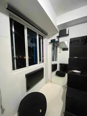 a small room with a window and a chair in it at Khencob's Pad Quezon City in Manila