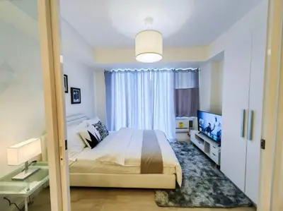 a bedroom with a large bed and a large window at 1BR Condotel at Azure Urban Resort Near Airport #AZ03 in Manila