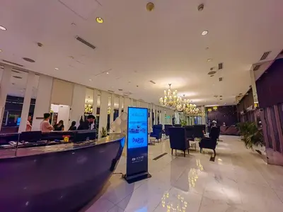 a lobby with a bar with people sitting at tables at 1BR Condotel at Azure Urban Resort Near Airport #AZ01 in Manila