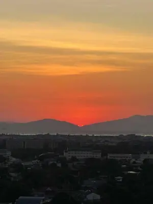 a sunset over a city with mountains in the background at 1BR Condotel at Azure Urban Resort Near Airport #AZ04 in Manila