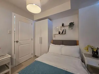 a small bedroom with a bed and a white door at 1BR Condotel at Azure Urban Resort Near Airport #AZ04 in Manila