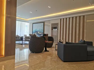 a man sitting on a couch in a living room at Shore 3 residence mall 'of Asia in Manila