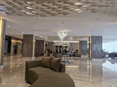 a lobby with a couch in the middle of a building at Moa shore 3 residence in Manila