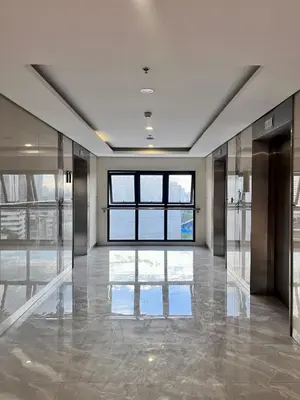 an empty lobby with glass doors and a large window at Deluxe Executive Corner Unit in Makati in Manila