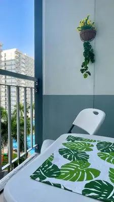 a bedroom with a balcony with a bed and a plant at Shell Residences Condo Suite Staycation near MOA and Airport in Manila