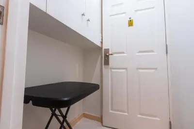 a black stool next to a white door at Hotel Sogo Guadalupe in Manila