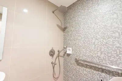 a shower stall in a bathroom with a shower at Hotel Sogo Guadalupe in Manila