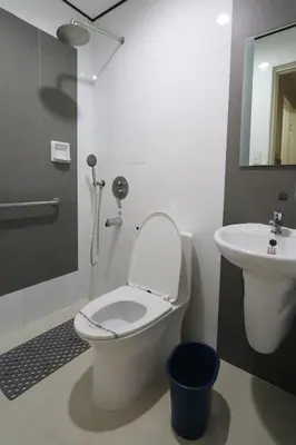 a bathroom with a toilet and a sink at Hotel Sogo Makati Avenue in Manila