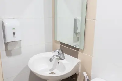 a bathroom with a sink and a mirror at Hotel Sogo Makati Avenue in Manila