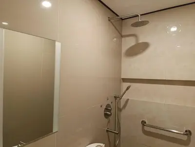 a bathroom with a shower with a glass door at Hotel Sogo Quirino in Manila