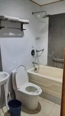 a bathroom with a toilet and a shower and a sink at Hotel Sogo Molino in Cavite