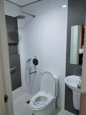 a bathroom with a toilet and a sink at Hotel Sogo Molino in Cavite