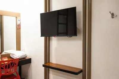 a flat screen tv hanging on a wall at Hotel Sogo Santolan in Manila