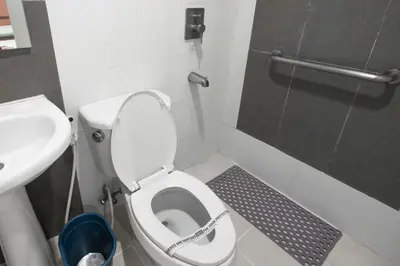 a small bathroom with a toilet and a sink at Hotel Sogo Santolan in Manila