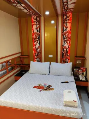 a bedroom with a large white bed with a book on it at Hotel Sogo Recto in Manila
