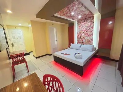 a room with a bed and a table and chairs at Hotel Sogo Sta Rosa in Santa Rosa